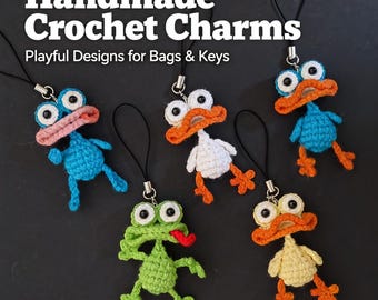 May include: Handmade crochet charms in the shape of whimsical animals, including a blue duck, a white duck, a green frog, and a yellow duck. The charms have large eyes and are attached to black lanyards. Text reads "Handmade Crochet Charms, Playful Designs for Bags & Keys."