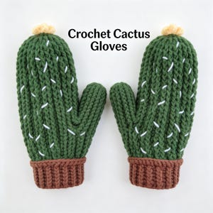 May include: A pair of green crochet mittens designed to resemble cacti, with white stitch details and brown cuffs. The mittens have a yellow pom-pom at the top and the text "Crochet Cactus Gloves".
