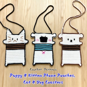 May include: Three handmade crochet phone pouches in the shape of a cat, a puppy, and a bear. The pouches are white with brown and black accents, and each has a long black or brown strap. The text "Puppy & Kitten Phone Pouches, Cat & Dog Coasters" is visible.