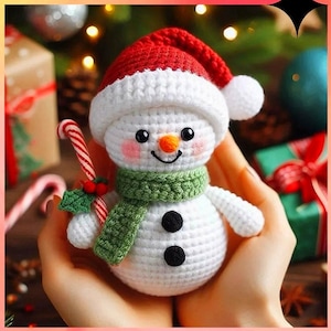 May include: A white crocheted snowman with a red and white hat, green scarf, and black eyes and buttons. The snowman is holding a candy cane with a green holly sprig.