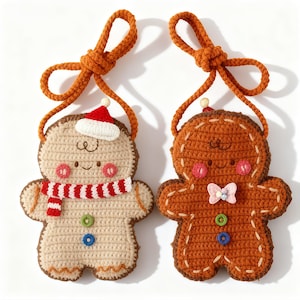May include: Two crocheted gingerbread man ornaments. One is tan with a red and white scarf and Santa hat. The other is brown with a pink bow tie. Both have orange rope hangers and pink cheeks.