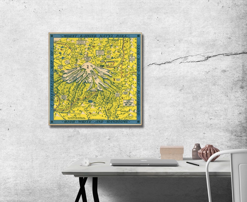 May include: A vintage map of Mount Rainier National Park in Washington state. The map is yellow with blue borders and features a stylized illustration of Mount Rainier. The text "Mount Rainier Nat'l Park" is at the top of the map and "High, White and Handsome" is at the bottom.