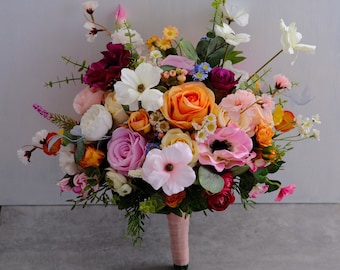 May include: A colourful bouquet of flowers in shades of pink, orange, white, and yellow. The bouquet includes roses, anemones, and other blooms.