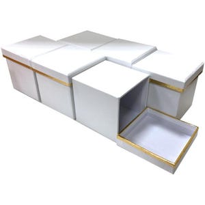 May include: White square gift boxes with gold trim. One box is open, revealing the interior. The boxes are arranged in a cluster, with the open box positioned in the foreground. The boxes are ideal for gifts or storage.
