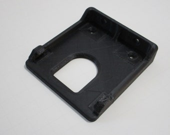 May include: Black plastic 3D printed wall mount with a rectangular opening and three holes.