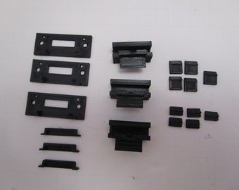 May include: A set of black 3D printed parts for a project. The set includes three rectangular pieces with holes, four small square pieces, three long rectangular pieces, and three short rectangular pieces.