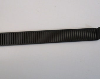 May include: Black plastic cable tie with a ribbed texture.