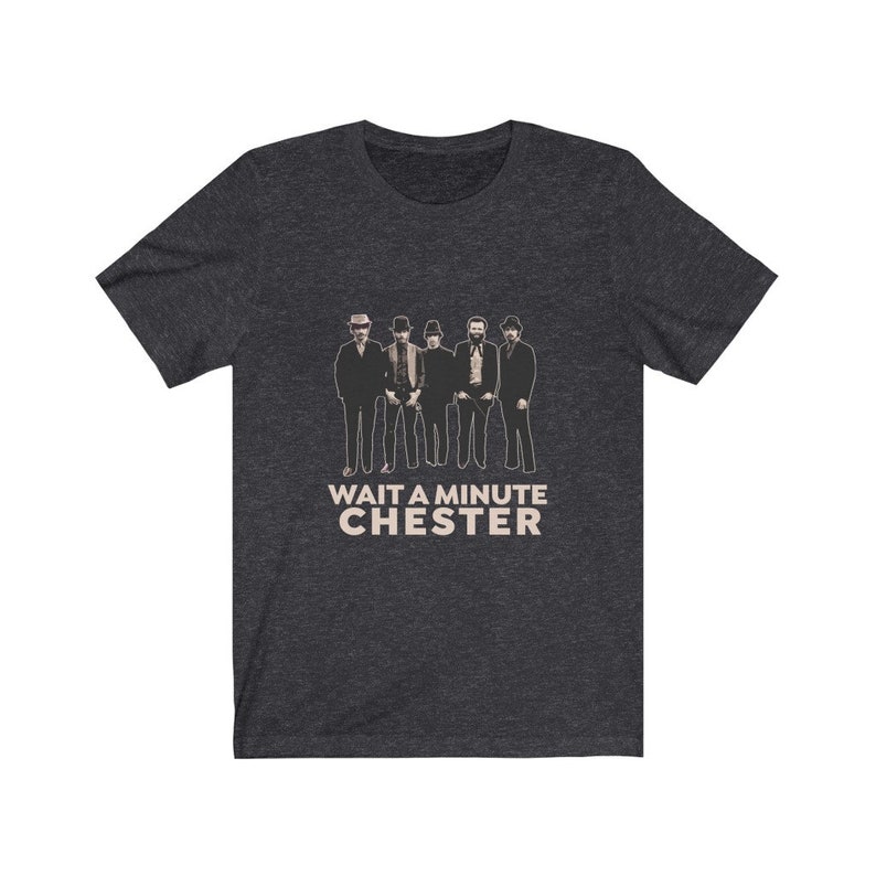 May include: A dark heather grey t-shirt with a black and white image of a band with the text "WAIT A MINUTE CHESTER" printed on the front.
