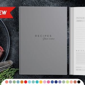 May include: A gray recipe journal with the text "RECIPES Your name" on the cover. The journal has a white interior with lined pages for writing down recipes, ingredients, and notes.