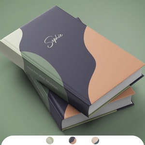 May include: Two hardcover books stacked on top of each other. The top book has a navy blue cover with a peach and light green abstract design. The word "Sophie" is written in cursive. The text "YOUR TEXT HERE (OPTIONAL)" is printed on the spine.