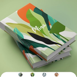 May include: Two hardcover books stacked on top of each other. The covers feature a botanical design with green leaves, an orange circle, and the name "Nina" in white script. The text "YOUR TEXT HERE (OPTIONAL)" is also visible.