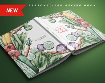 May include: A white personalized cookbook with a watercolor illustration of vegetables on the cover. The text "YOUR NAME COOK BOOK" is printed on the cover.