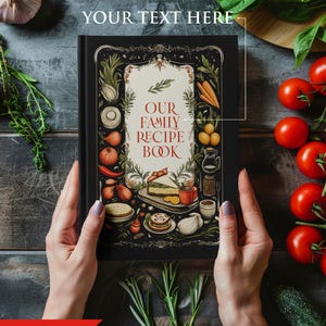 May include: A black hardcover recipe book with a colorful illustration of food and vegetables on the cover. The title of the book is "Our Family Recipe Book".