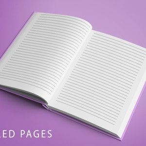 Op de afbeelding: Een open notitieboek met geruite pagina's, liggend op een paarse ondergrond. De tekst "RULED PAGES" is in wit onderaan de afbeelding gedrukt.
