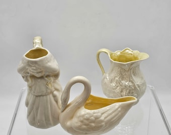 3 Belleek Collectible Creamers | Made in Ireland | Swan Pitcher | Udine Girl Pitcher | Lotus Pitcher | Markings Span From 1926 to 1965 |Mint