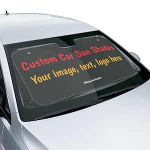 May include: A black car sunshade with the text "Custom Car Sun Shades" in red and "Your image, text, logo here" in yellow. The text "@MonkeyFeetGraphics" is in white at the bottom of the sunshade.
