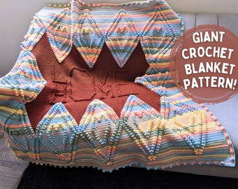 May include: A large, colorful crochet blanket with a textured, bobble stitch pattern. The blanket features a "HOME" design in the center and a repeating diamond pattern in shades of pink, blue, yellow, and green.