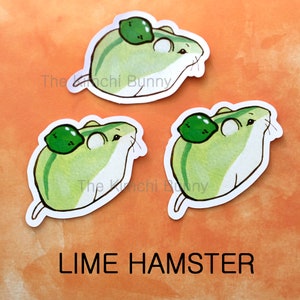 May include: Three stickers featuring cartoon hamsters with lime slices on their backs. The hamsters are green and white with black eyes and whiskers. The stickers are white with a black outline. The text "The Kinchi Bunny" is visible on two of the stickers. The text "LIME HAMSTER" is visible at the bottom of the image.