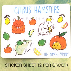May include: Sticker sheet with a citrus theme featuring hamsters. The sheet includes images of hamsters eating citrus fruits, such as oranges, lemons, and limes. The text "CITRUS HAMSTERS" and "THE KIMCHI BUNNY" are printed on the sheet. The sheet also includes the text "STICKER SHEET (2 PER ORDER)".
