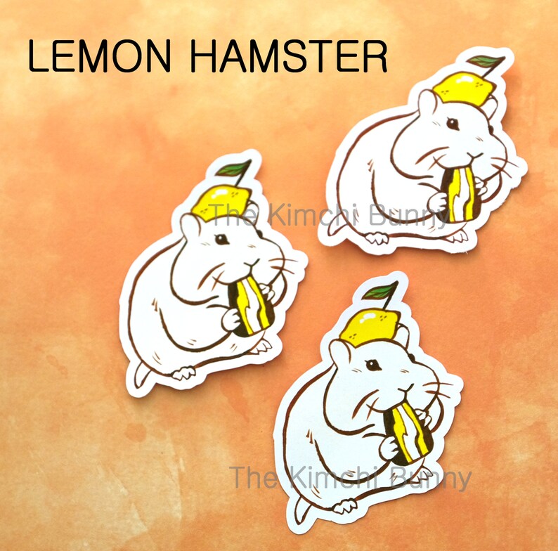 May include: Three white hamster stickers with yellow lemon hats and a slice of lemon in their mouths. The stickers say "Lemon Hamster" at the top.