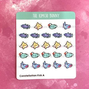 May include: A sheet of stickers featuring a variety of colorful fish designs. The stickers are arranged in rows and columns, with each fish having a unique design. The stickers are labeled "Constellation Fish A" and "The Kimchi Bunny".