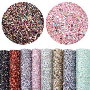 May include: Assortment of 10 sheets of glitter fabric in various colors, including black, red, silver, pink, gold, blue, and green. The fabric is covered in small, iridescent glitter.