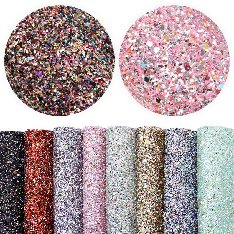 May include: Assortment of 10 sheets of glitter fabric in various colors, including black, red, silver, pink, gold, blue, and green. The fabric is covered in small, iridescent glitter.