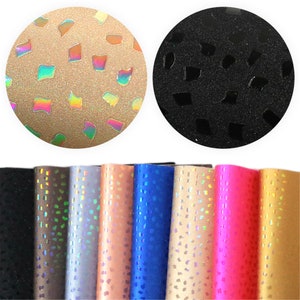 May include: Assortment of eight iridescent faux leather sheets with a geometric pattern. The sheets are in various colors, including black, brown, silver, peach, blue, gold, pink, and yellow.