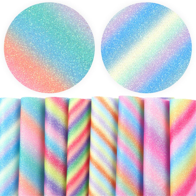 May include: A set of eight rainbow glitter fabric sheets with a diagonal stripe pattern. The fabric sheets are a light blue, pink, and purple color with a rainbow gradient.