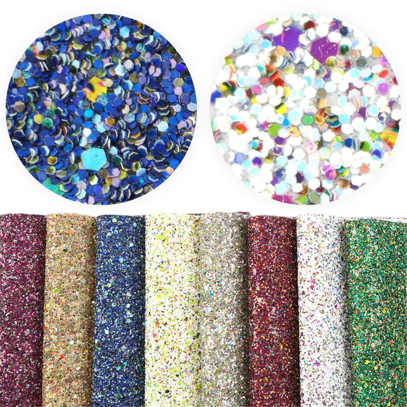 May include: Assortment of eight rolls of glitter fabric in various colors, including burgundy, gold, blue, white, and green. The fabric is covered in small, iridescent glitter.