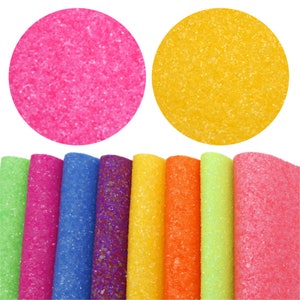 May include: Assortment of 10 glitter fabric sheets in various colors, including pink, blue, yellow, orange, and green. The sheets have a textured, sparkly finish.