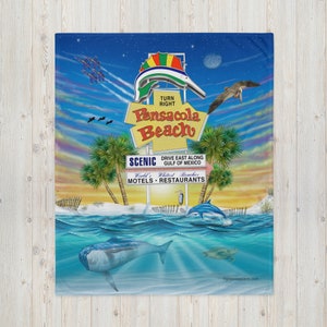 May include: A colorful illustration of a sign for Pensacola Beach, Florida. The sign features a stylized fish jumping out of the water, with the words "Turn Right" and "Pensacola Beach" in yellow letters. The sign also includes the text "Scenic Drive East Along Gulf of Mexico" and "World's Whitest Beaches Motels - Restaurants". The image is set against a blue sky with white clouds and a sunset in the background.