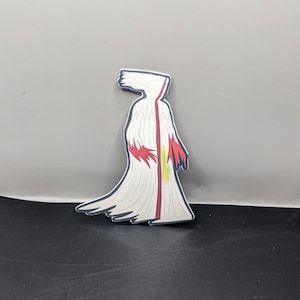 May include: A white sticker with a red and white figure wearing a long white robe with a red stripe down the center. The figure has a white head with a red and white design.
