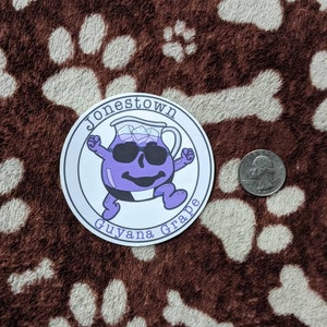 May include: A round sticker with a cartoon purple pitcher wearing sunglasses and the text "Jonestown Guyana Grape".