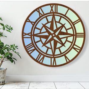 May include: A wooden wall clock with a compass design and Roman numeral markings. The clock face has a gradient of blue and green colors.