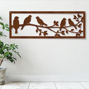 May include: Brown metal wall art featuring a silhouette of a branch with five birds perched on it. The branch has leaves and the birds are facing different directions.