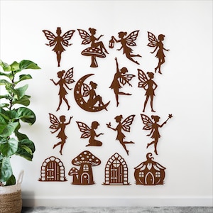 May include: Wooden fairy wall art set featuring various fairy silhouettes, a crescent moon with fairies, and fairy house cutouts. The fairies have detailed wings and are in different poses. The set is made of brown wood and is displayed on a white wall.