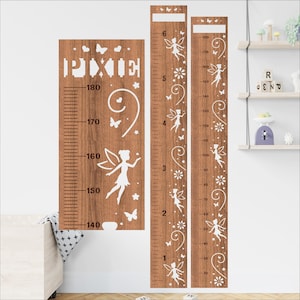 May include: Wooden height chart with a fairy theme. The chart is brown with white cut-out designs of fairies, butterflies, and flowers. The word "PIXIE" is at the top. Measurements are in inches and centimeters.
