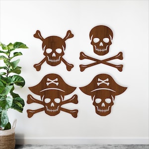 May include: Four wooden pirate-themed wall decorations. The designs include a skull and crossbones, and skulls with pirate hats. The decorations are brown and mounted on a white wall. The style is rustic and suitable for a nautical or pirate-themed room.