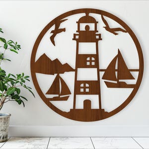 May include: A wooden wall decor featuring a lighthouse, two sailboats, and seagulls. The design is cut out of a circular piece of wood and has a brown wood finish.