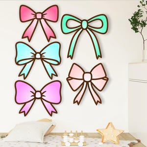 May include: Six colorful bow designs in pink, blue, and green. The bows are drawn in a cartoon style and are perfect for a nursery or children's room.