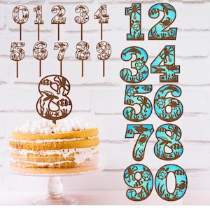 May include: Set of ten wooden cake toppers, numbers 0-9, with a sea life design. The numbers are brown and the sea life design is blue and white.