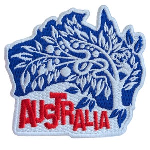 May include: An embroidered patch in the shape of Australia with a blue and white tree design and the word "AUSTRALIA" in red.