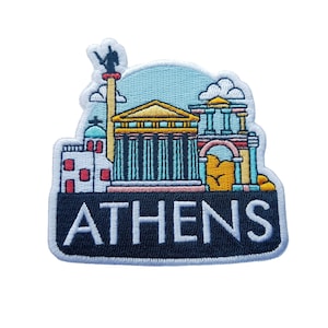 以下が含まれることがあります： アテネのギリシャのアクロポリスのカラフルなイラストが刺繍されたパッチ。パッチは白地に黒で、「ATHENS」という文字が白で書かれています。