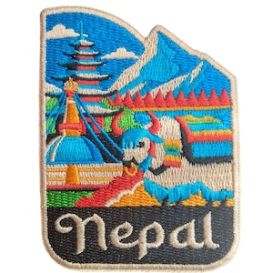 May include: Embroidered patch depicting a vibrant scene of Nepal, with mountains, a pagoda, and a yak. The patch has a black border and the word "Nepal" embroidered in a script font at the bottom.