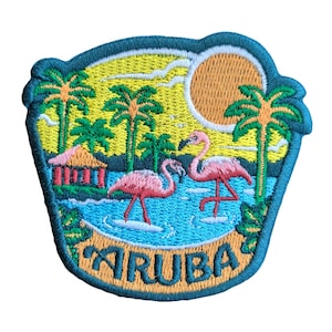 May include: Embroidered patch with a colorful scene of palm trees, a hut, and two pink flamingos in a blue lagoon. The text "ARUBA" is written in a yellow arch at the bottom of the patch.