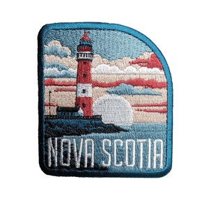 May include: Embroidered patch featuring a red and white lighthouse against a blue sky and ocean. The text "NOVA SCOTIA" is embroidered in white on a blue background.