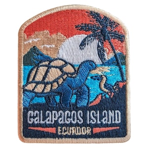 May include: Embroidered patch depicting a Galapagos Island scene. The design includes a blue turtle, a palm tree, and a sunset with the text "GALAPAGOS ISLAND ECUADOR". The patch has a tan border and is rectangular with rounded corners.