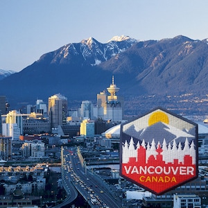 May include: A scenic view of Vancouver, Canada, featuring a cityscape with mountains in the background. A patch with a mountain and cityscape design is in the foreground, with the text "Vancouver Canada".