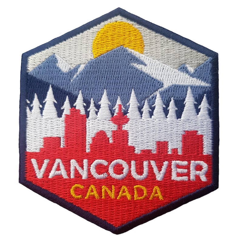 May include: Embroidered patch featuring a scenic view of Vancouver, Canada. The design includes a red cityscape, white trees, blue mountains, and a yellow sun against a white and blue sky. The text "VANCOUVER CANADA" is prominently displayed.